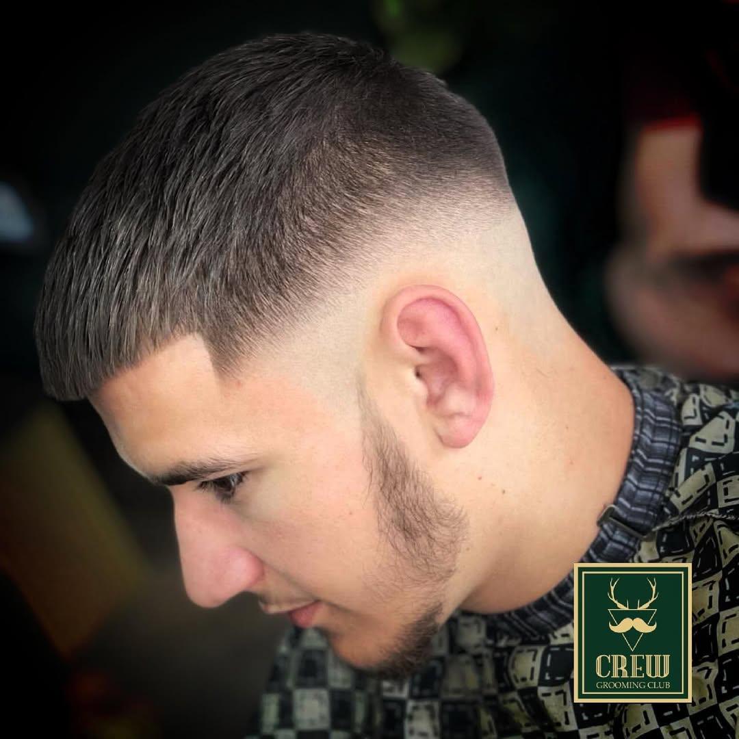 Tight skin fade and textured crop finish on a male client at Crew Barbers Isleworth